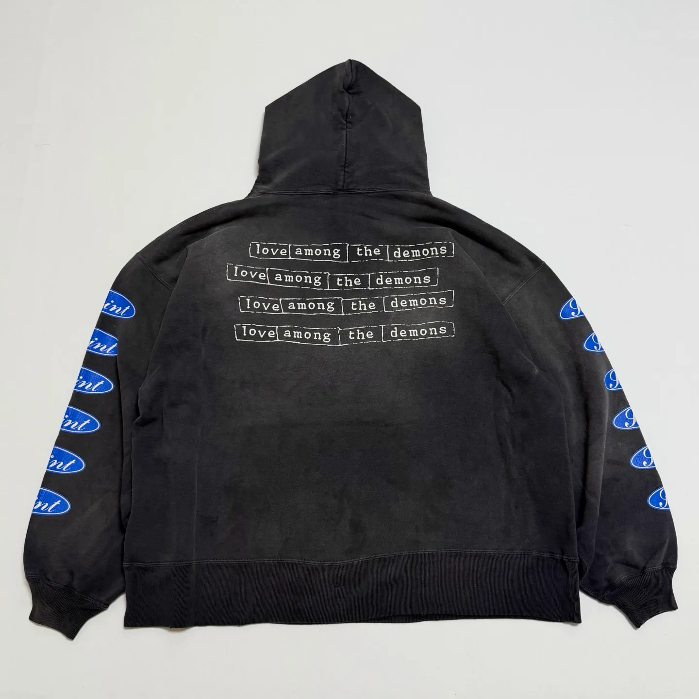 More details SAINT Mxxxxxx HOODIE/LOVE AMONG/BLK blue SAINT barrage slogan hoodie, washed black S-XL, the latest version, revised many times, the version is closer to the original version, and the street flavor is stronger! Heavy washing with water-sprayed fading process for stronger distressing effect. Handmade wormhole destruction treatment. Authentic level extreme distressed crack printing. The main mark and wash mark are all correct versions.